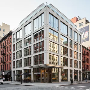 The sleek, modern exterior of the Modernhaus SoHo hotel, situated on a vibrant street corner in the heart of SoHo, Manhattan.