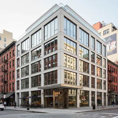 The sleek, modern exterior of the Modernhaus SoHo hotel, situated on a vibrant street corner in the heart of SoHo, Manhattan.